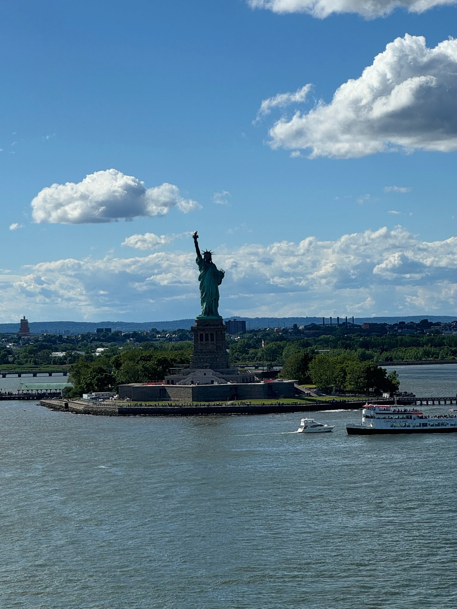 Cruise ship sailing past the Statue of Liberty from New York