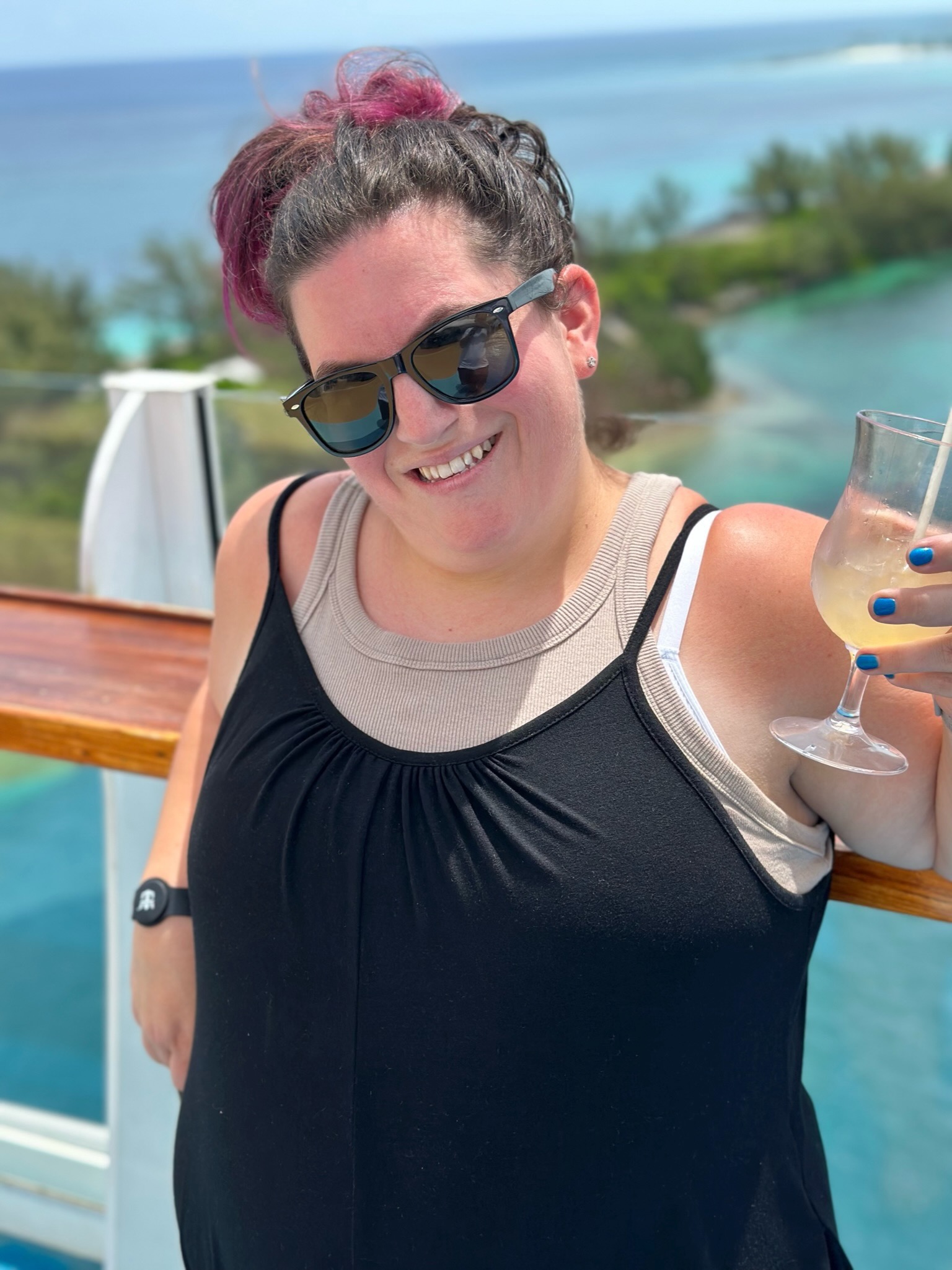 Kelly relaxing on a cruise ship deck with tropical water behind her